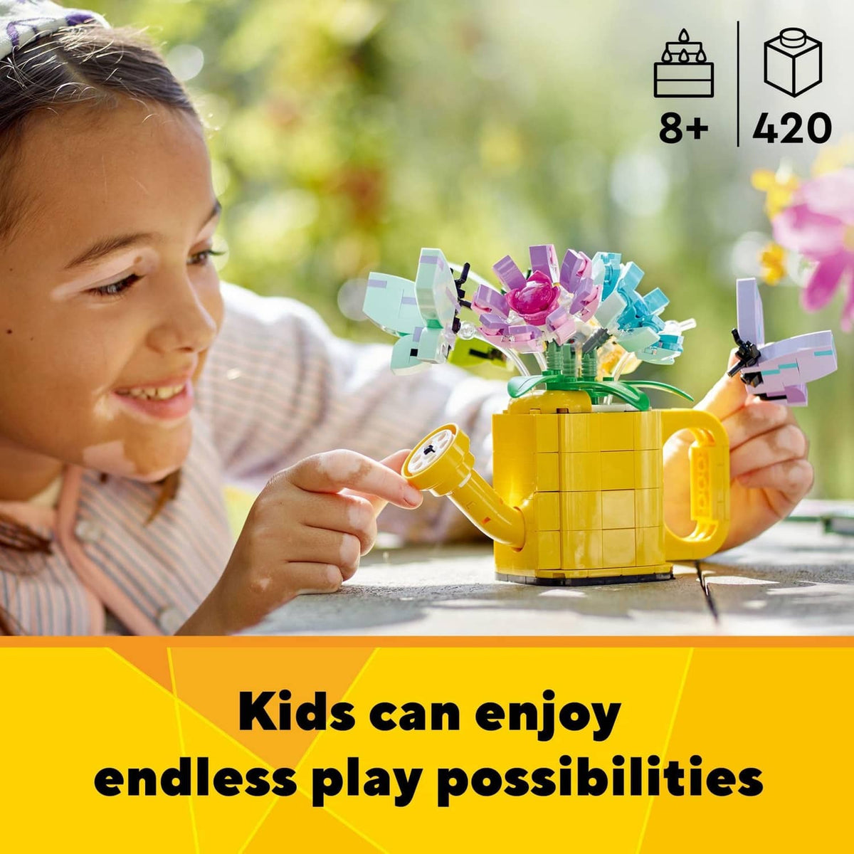 Child holding a LEGO Creator yellow watering can with multicolor flower pieces