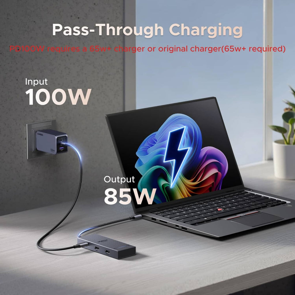 USB-C docking station on a desk with power input cable and laptop connection