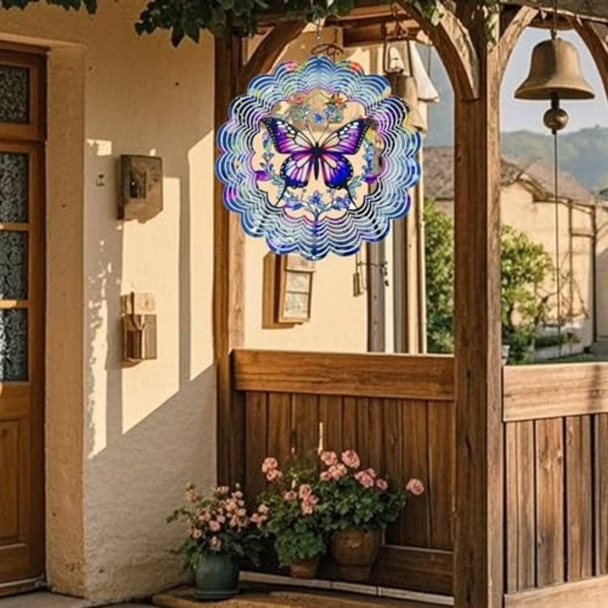 Butterfly wind spinner with multicolor scalloped rings hanging on a porch.