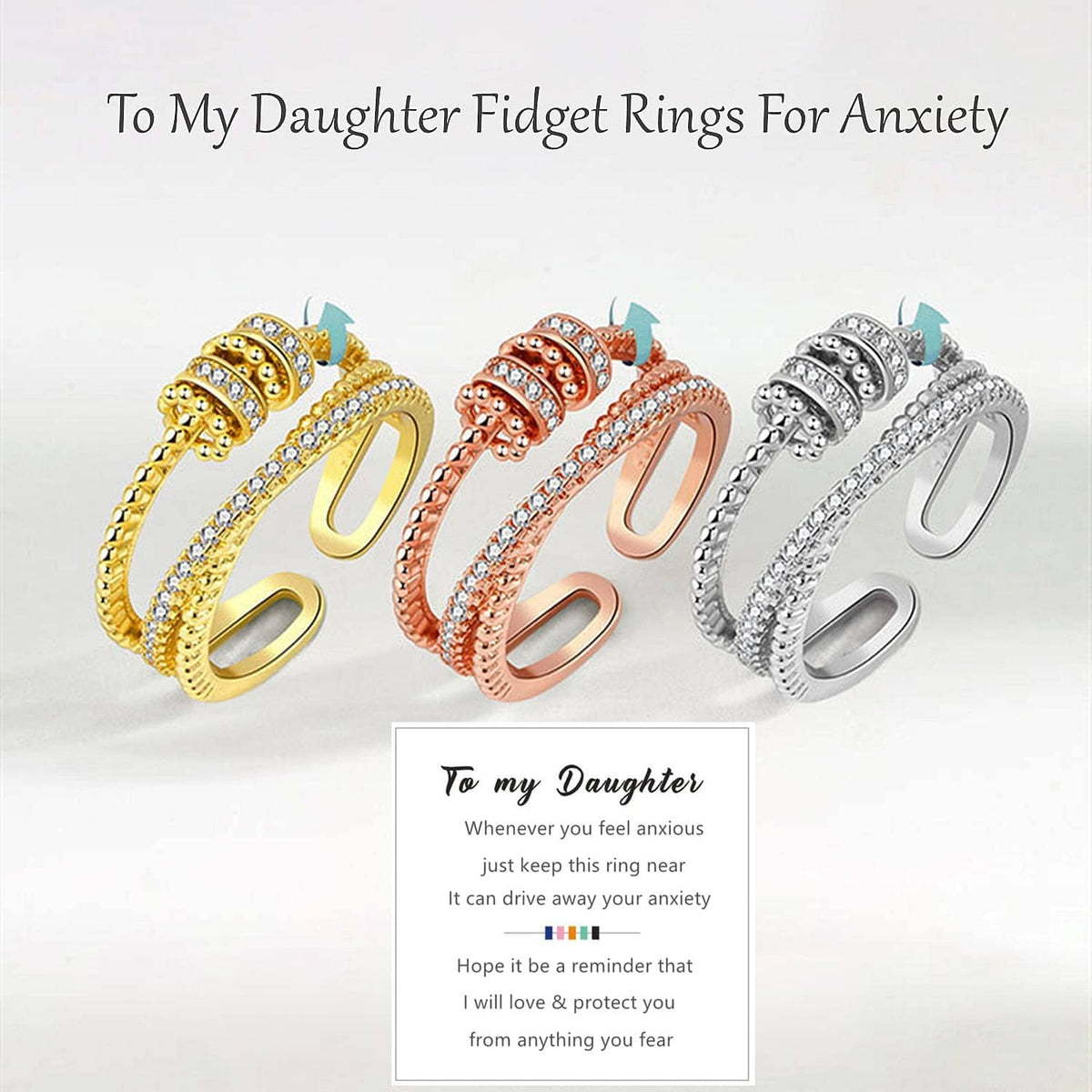 Set of three fidget rings in gold, rose gold, and silver tones with clear stones