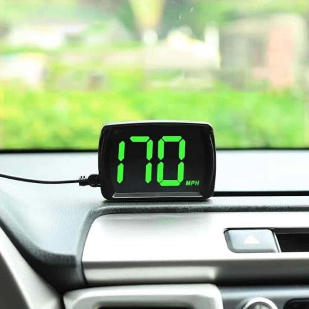 Black GPS HUD speedometer mounted on car dashboard with green MPH digits