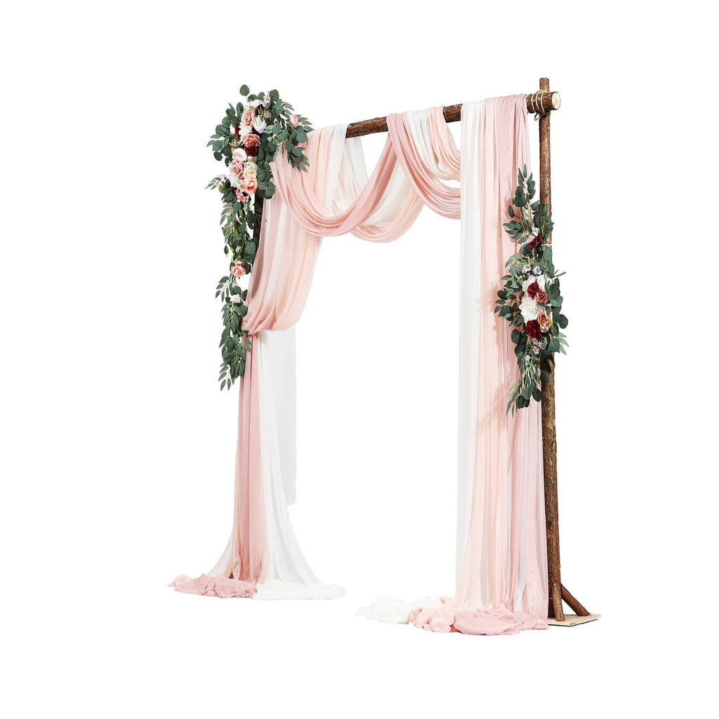 Artificial wedding arch flower kit with tall pink drape panels and floral arch decor