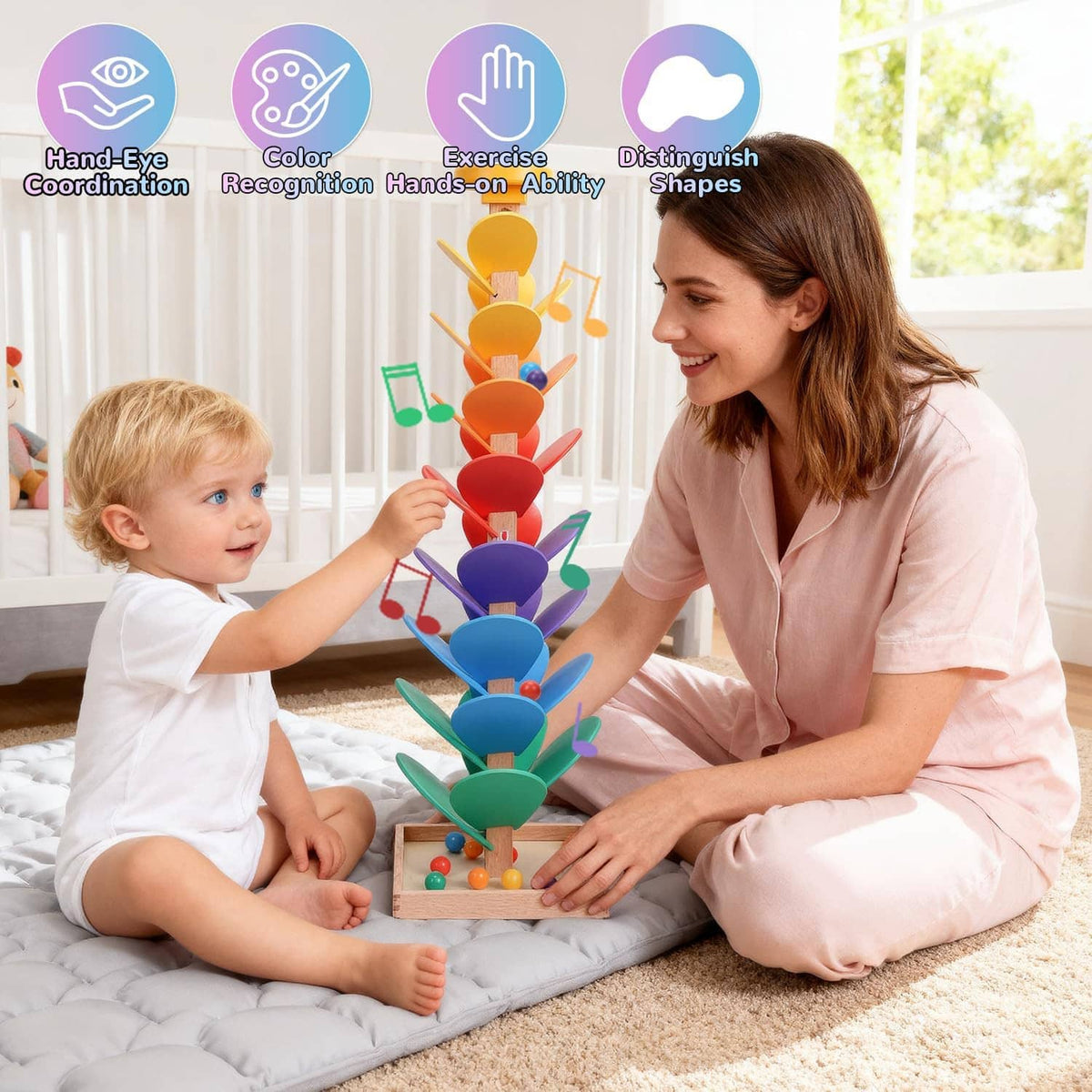 Child and caregiver playing with colorful wooden rainbow music marble run tree toy