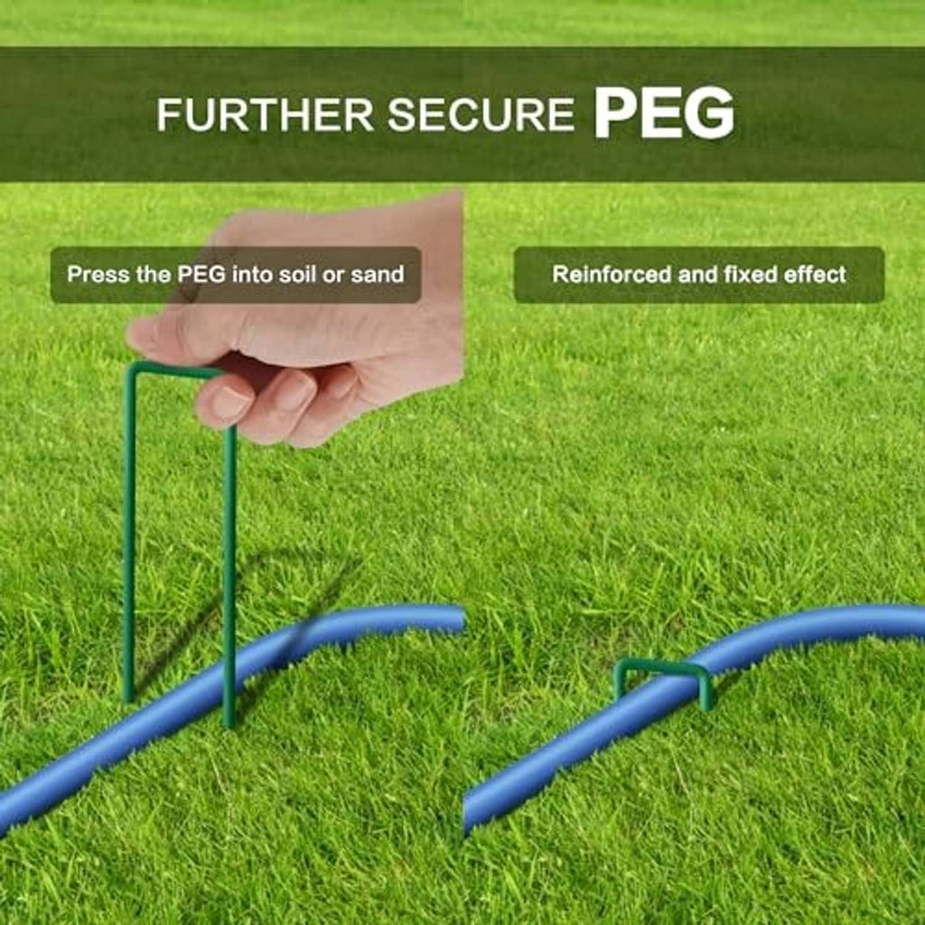 Garden hose mister tubing secured with metal peg on green grass