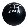 Round black gear shift knob with white numbers and prison-themed markings