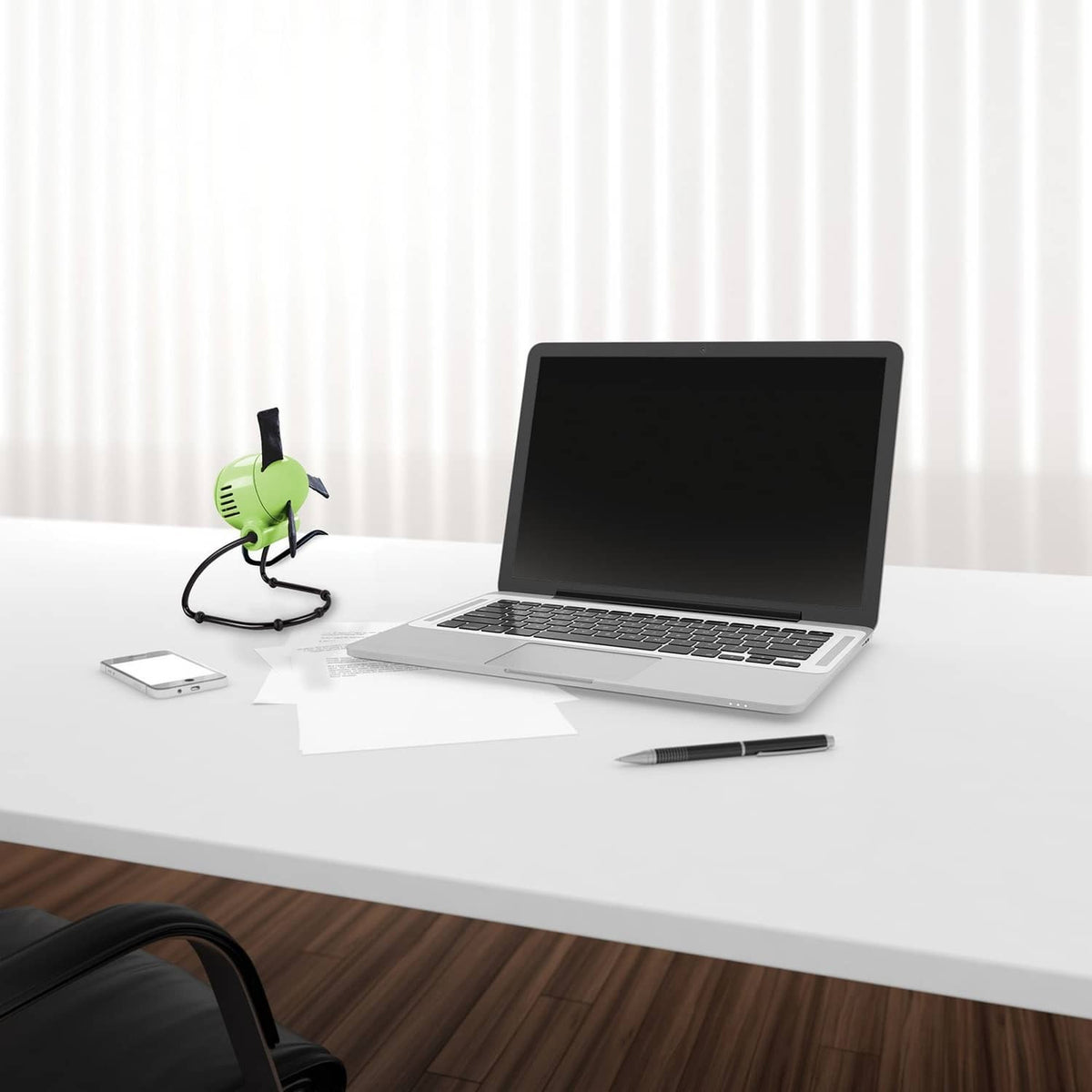 Green foldable personal fan with vented front grille and flexible black arms
