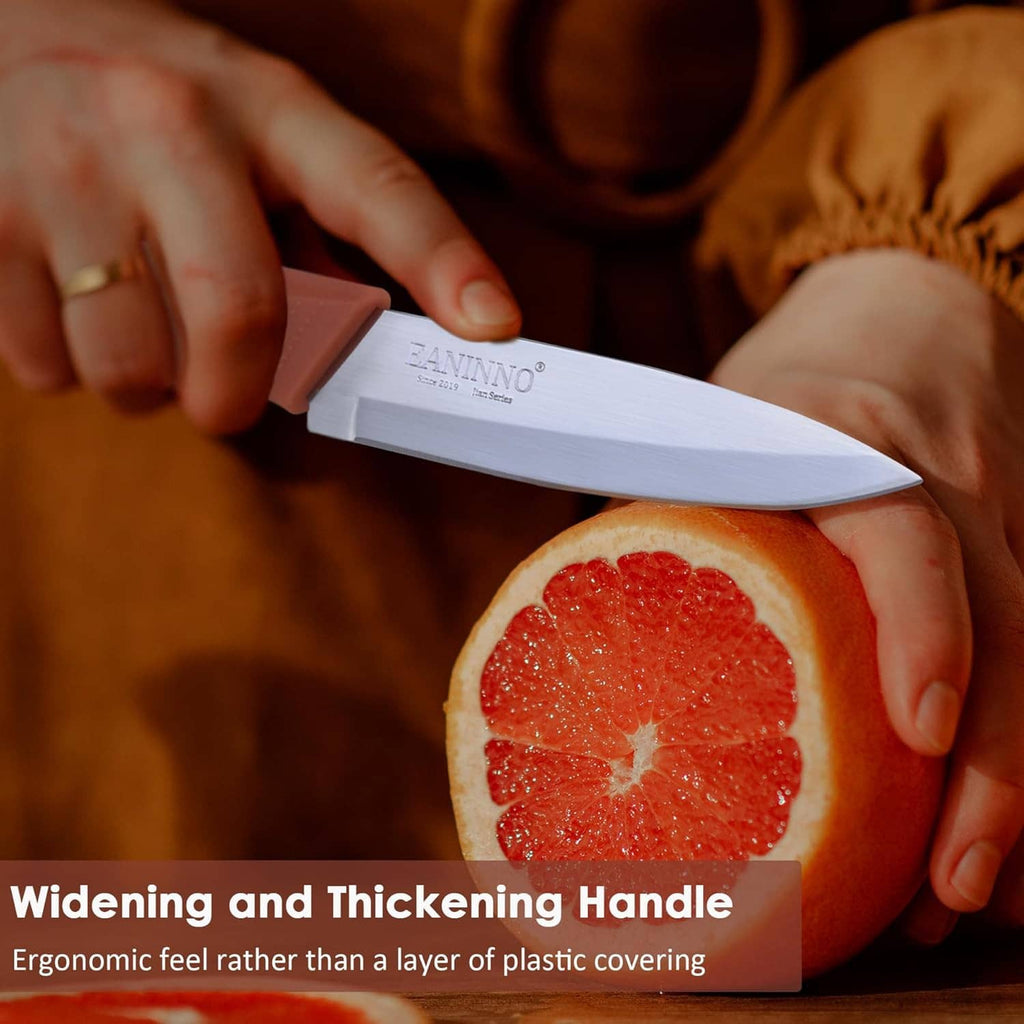 Paring knife with white blade being used to cut citrus on a cutting board
