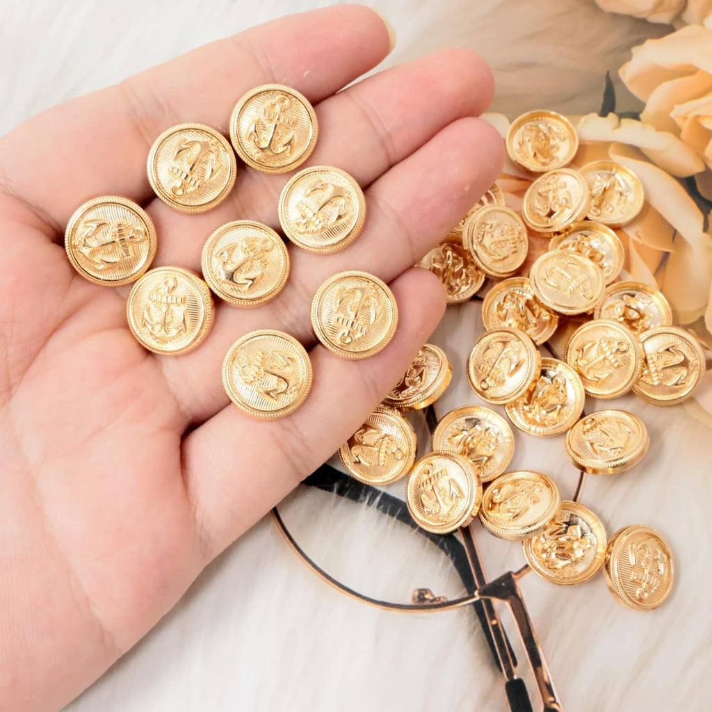 Gold round anchor sewing buttons, shown in hand, small 15mm size