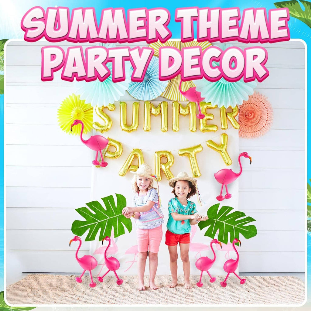 Pink flamingo inflatable decorations with orange beaks arranged in a party display