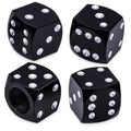 Four black dice-style tire valve stem caps with silver dots, angled view set