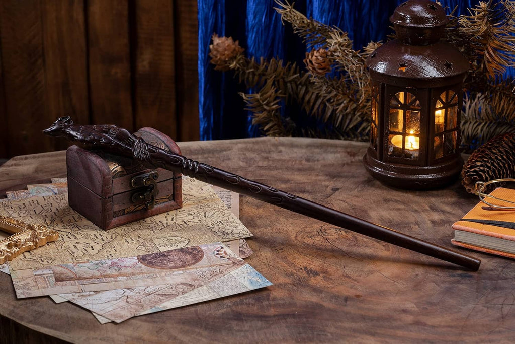 Dark brown carved wooden witch wand on tabletop with hand holding the handle