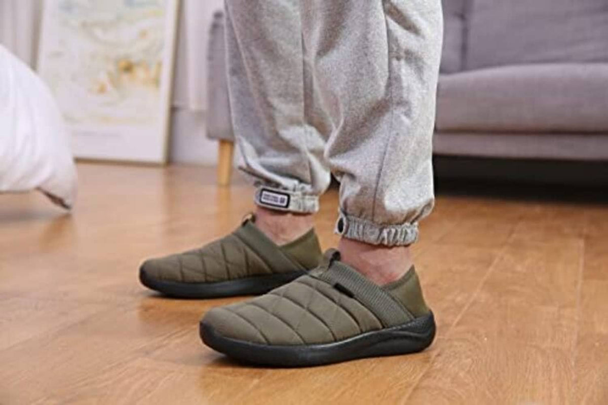 Army green quilted slip-on slippers worn with gray jogger pants