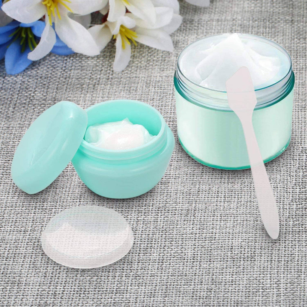 Mint and white 1 oz plastic toiletry jars with lids and a small spatula
