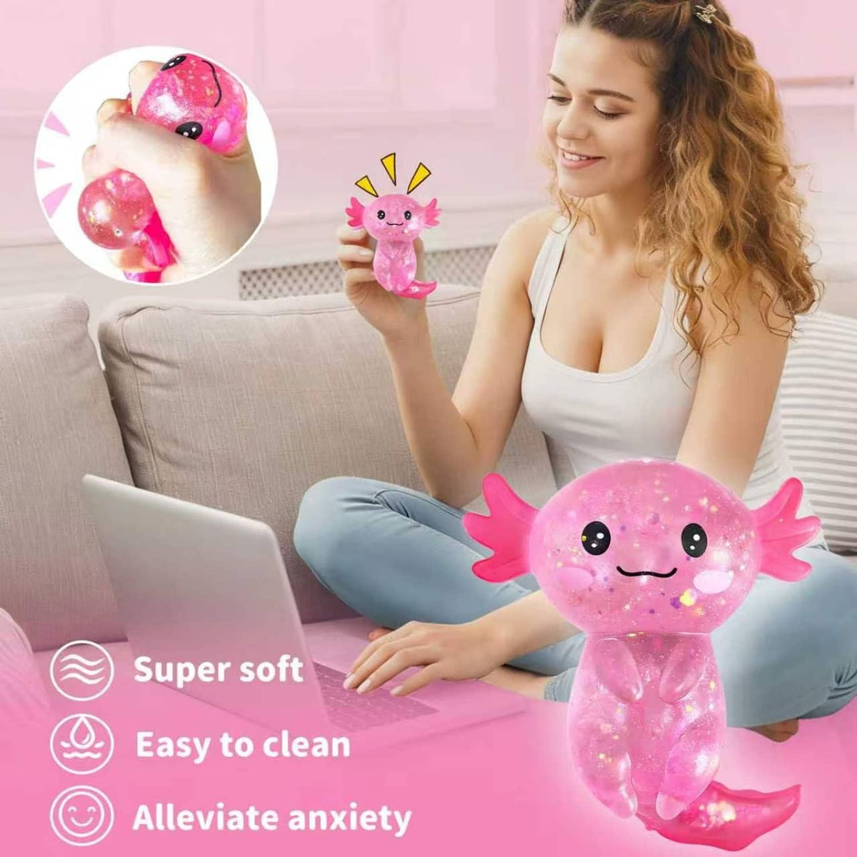 Pink glitter axolotl squish toy with smiling face, curled tail, held for play