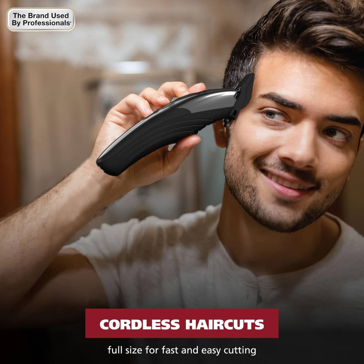 Handheld cordless hair clipper held near a man’s hair for cutting