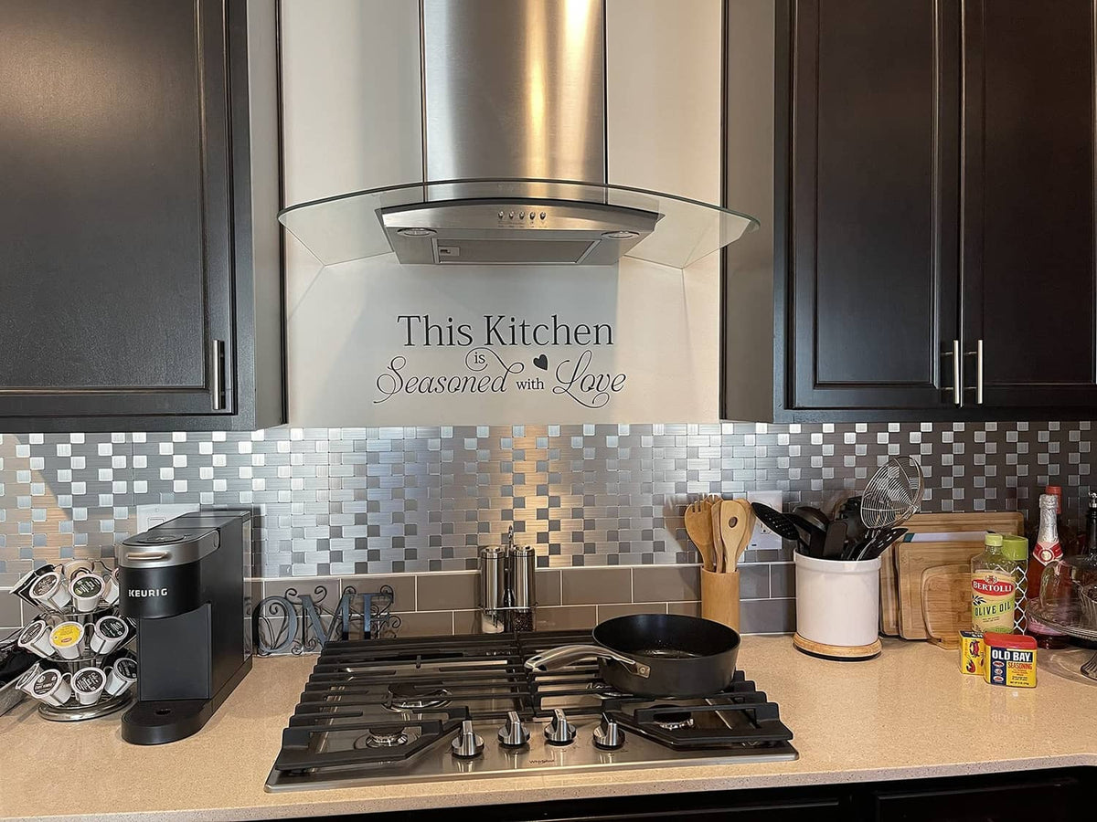 Kitchen backsplash made of gray and white square brick metal tiles behind stovetop