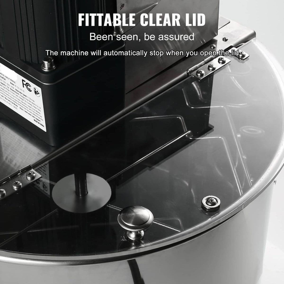 Electric honey extractor with motor housing and fitted clear protective cover