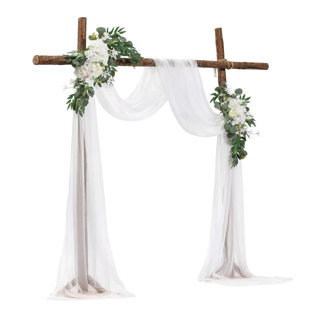 Artificial wedding arch flower kit with white drapes and faux greenery blooms on wooden frame