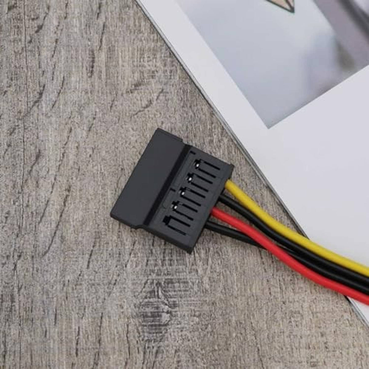 15-pin SATA female connector housing with red/yellow/black wires on 4-pin FDD adapter cord