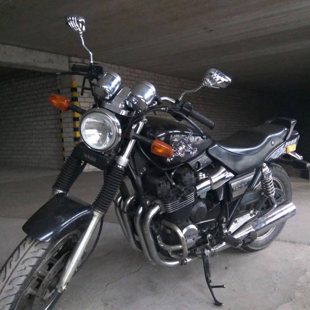 Chrome skull-hand rearview mirrors mounted on a black motorcycle