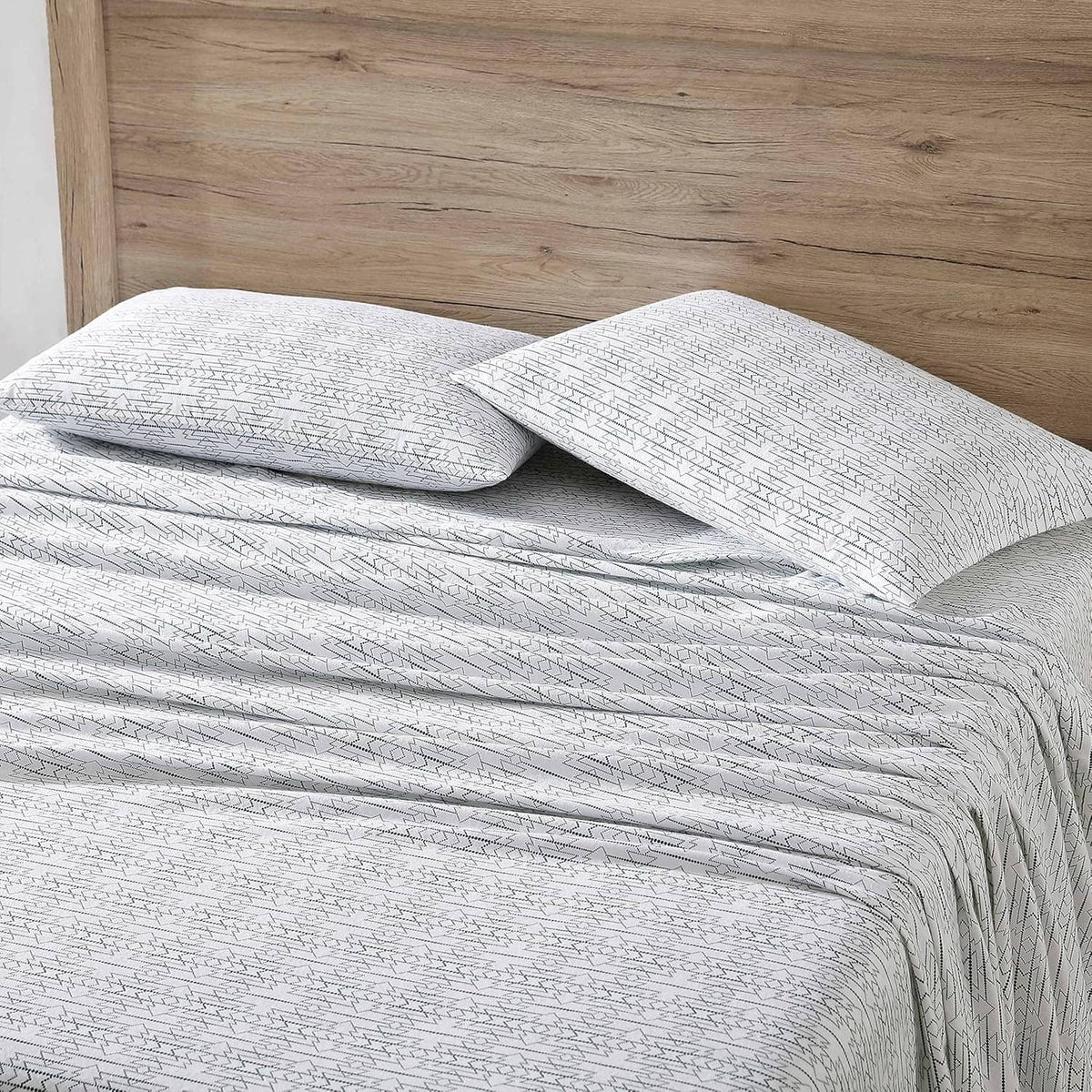 Queen cotton flannel sheet set with white base and navy geometric stripe; pillow and sheet