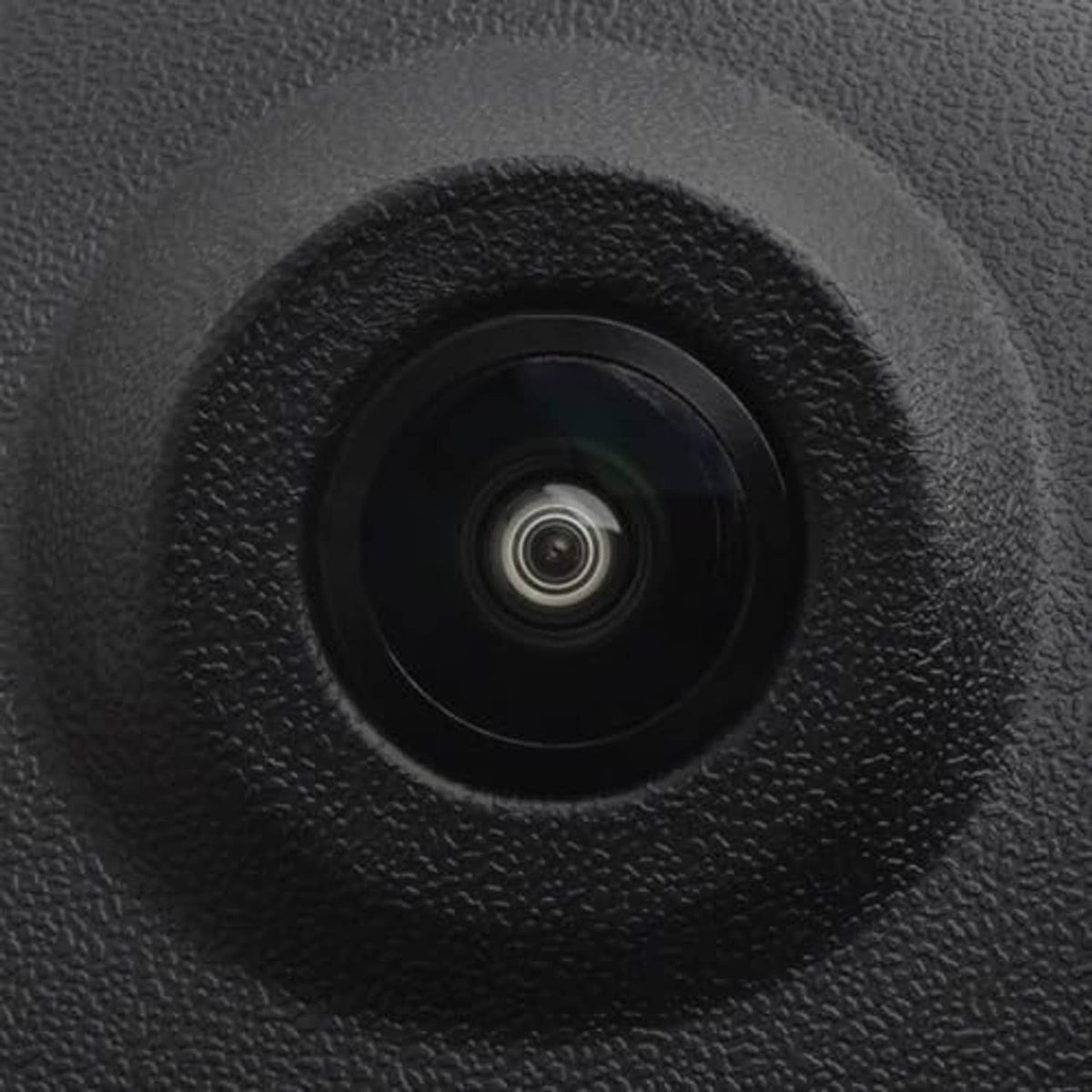 Close-up of backup camera lens in black textured housing