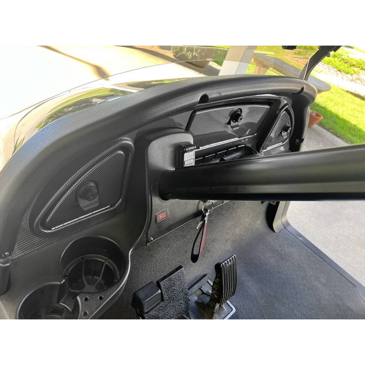Carbon-fiber-look dash trim installed with open compartments and hardware for locking door