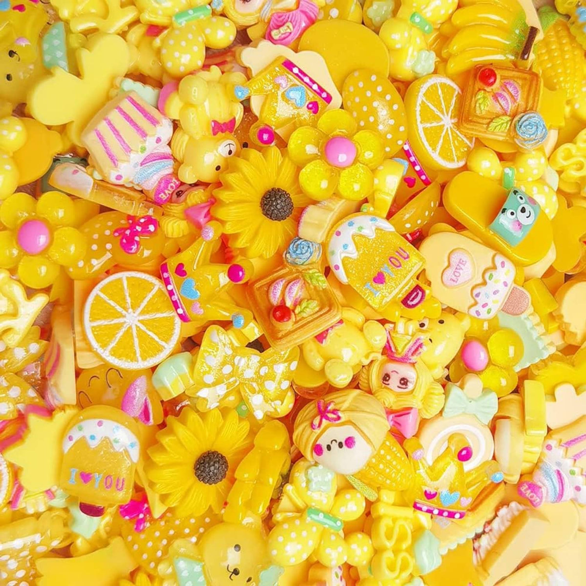 Assorted yellow flatback resin buttons with sunflowers, lemons, and animal/fruit faces