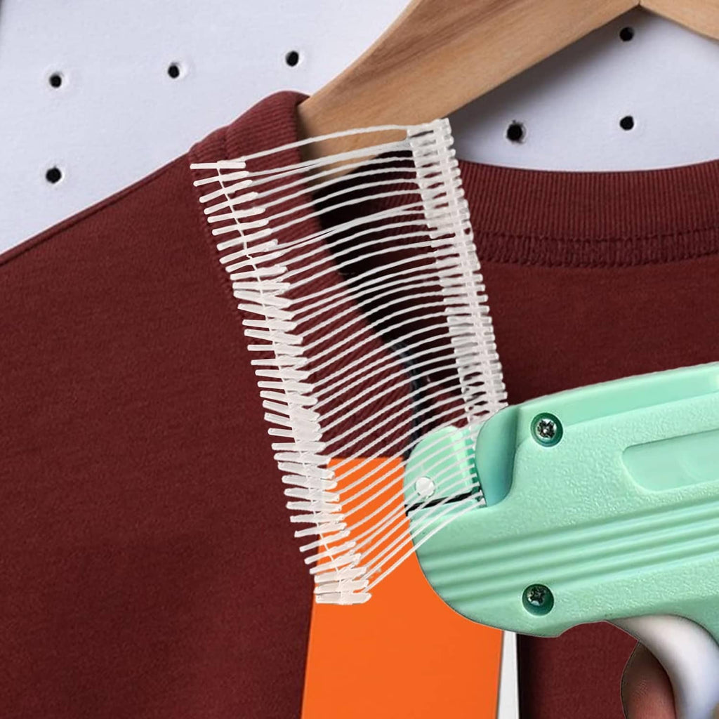 Tag gun refill strip being pressed onto a clothing tag with metal prongs