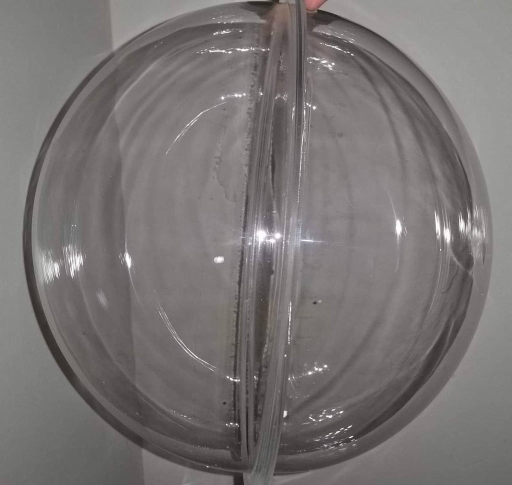 Clear acrylic dome hemisphere with central seam line and reflective surface.
