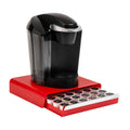 Red single-serve coffee pod drawer with black brewer base and pod slots on tray