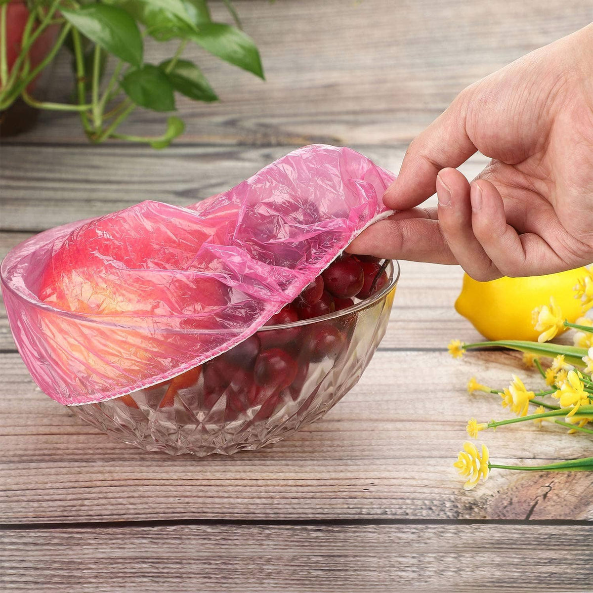 Pink elastic reusable food cover stretched over a bowl to keep food covered