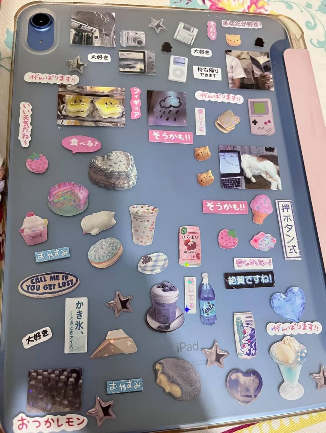 Sticker sheet with gray background featuring small icons, charms, and label-style stickers