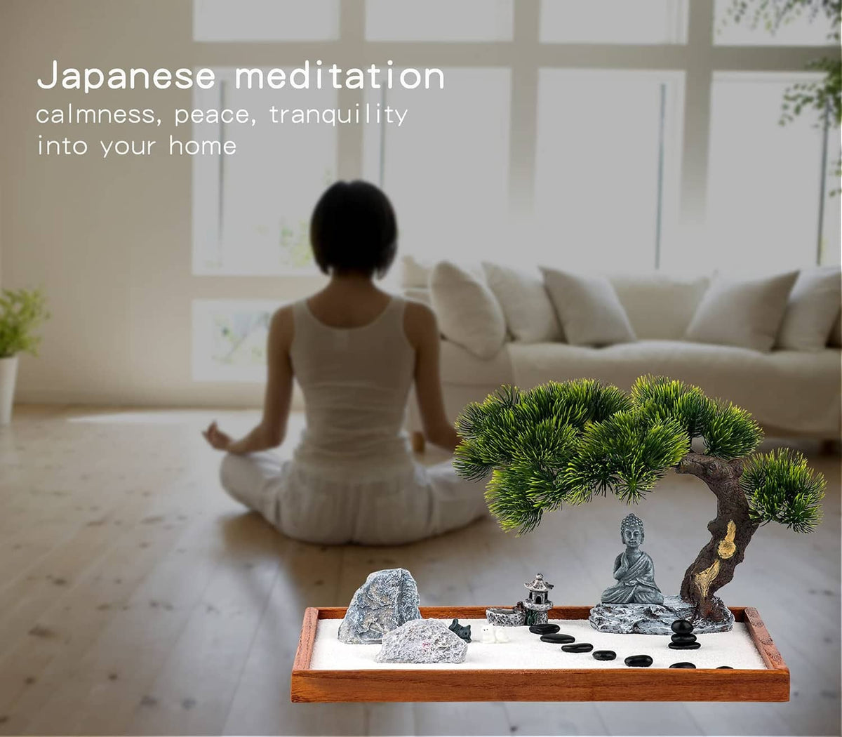 Mini zen garden kit on wooden tray with Buddha statue, rocks, pine tree, and black stones