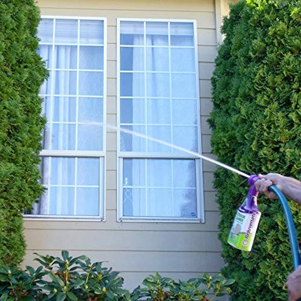 Window cleaner spray bottle misting outdoor window with purple trigger