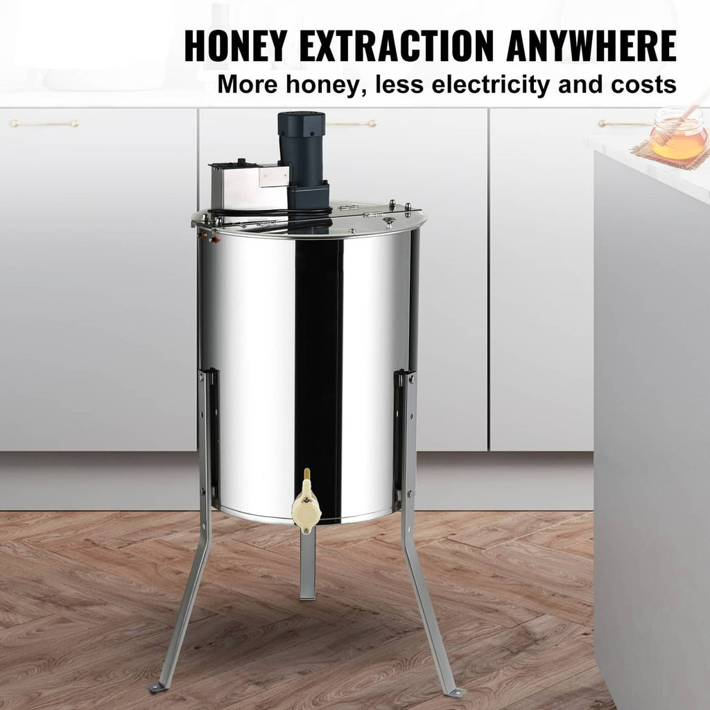 Electric honey extractor standing on tripod base with stainless steel drum
