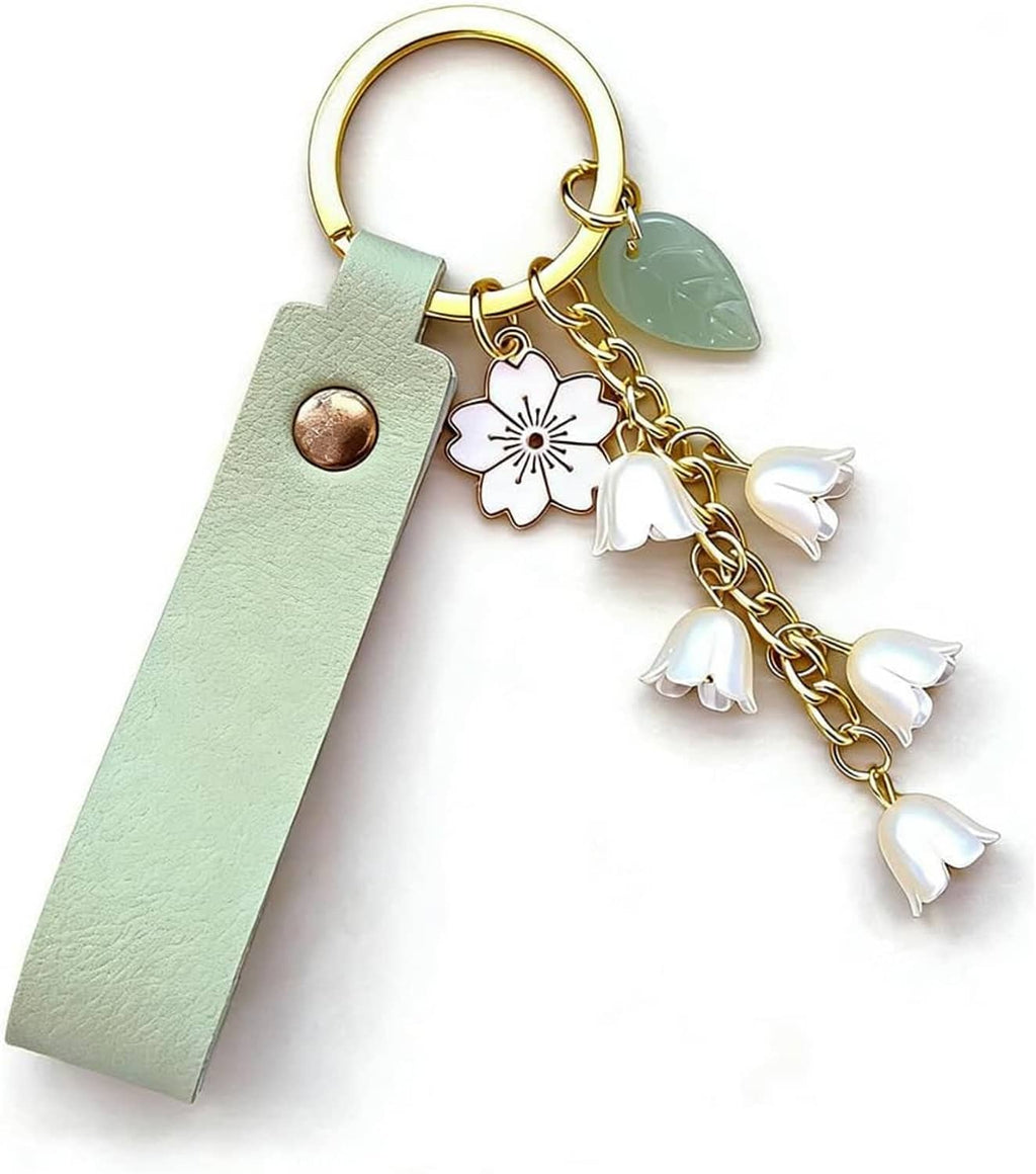 Mint green leather keychain with gold ring and white lily flower charm tassel dangles