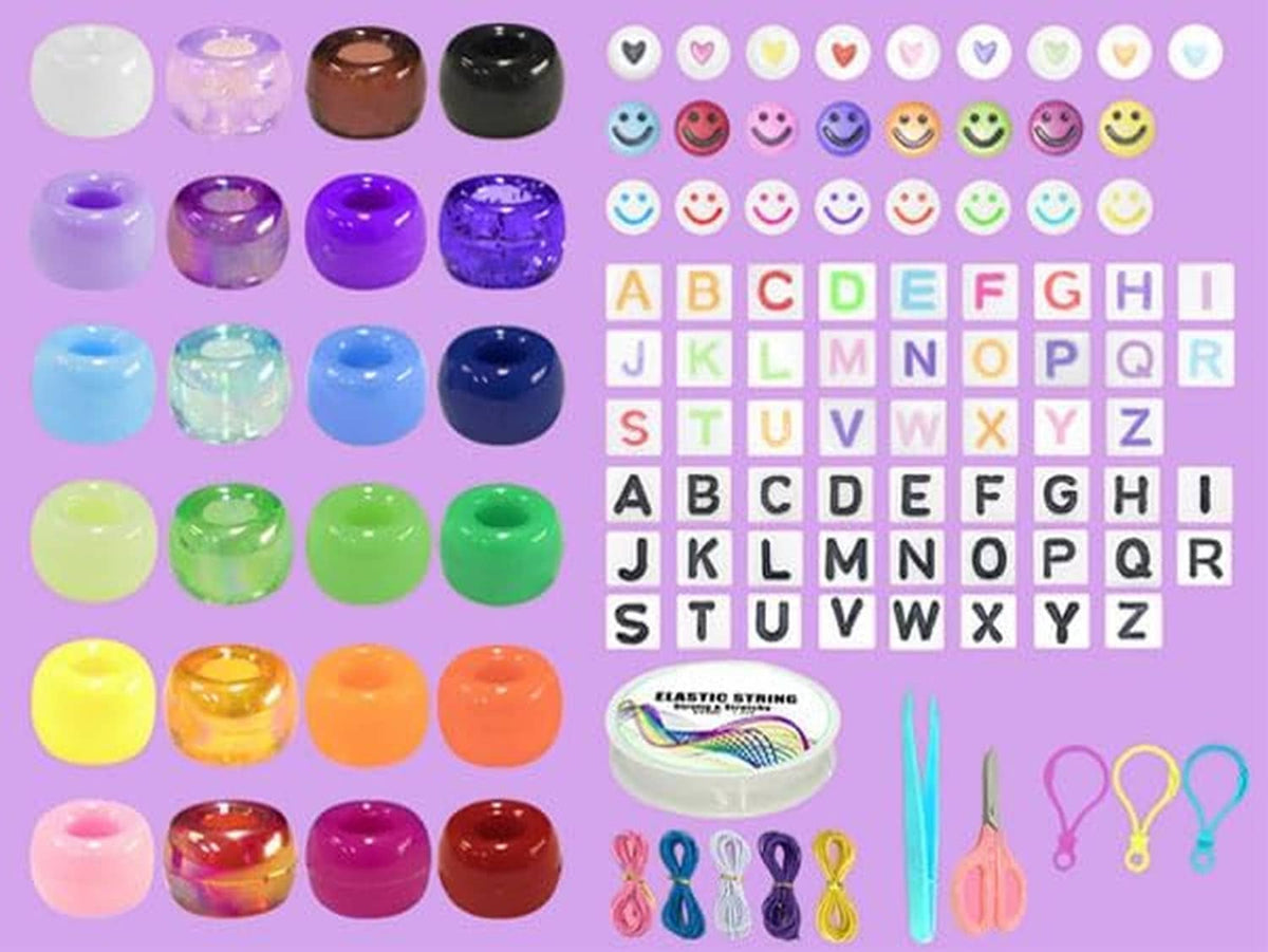 Assorted pony beads in small jars plus letter beads and elastic string strands