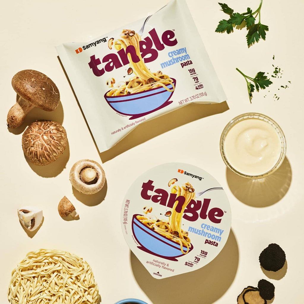 Tangle creamy mushroom pasta packets with serving cup, cream sauce, and mushrooms
