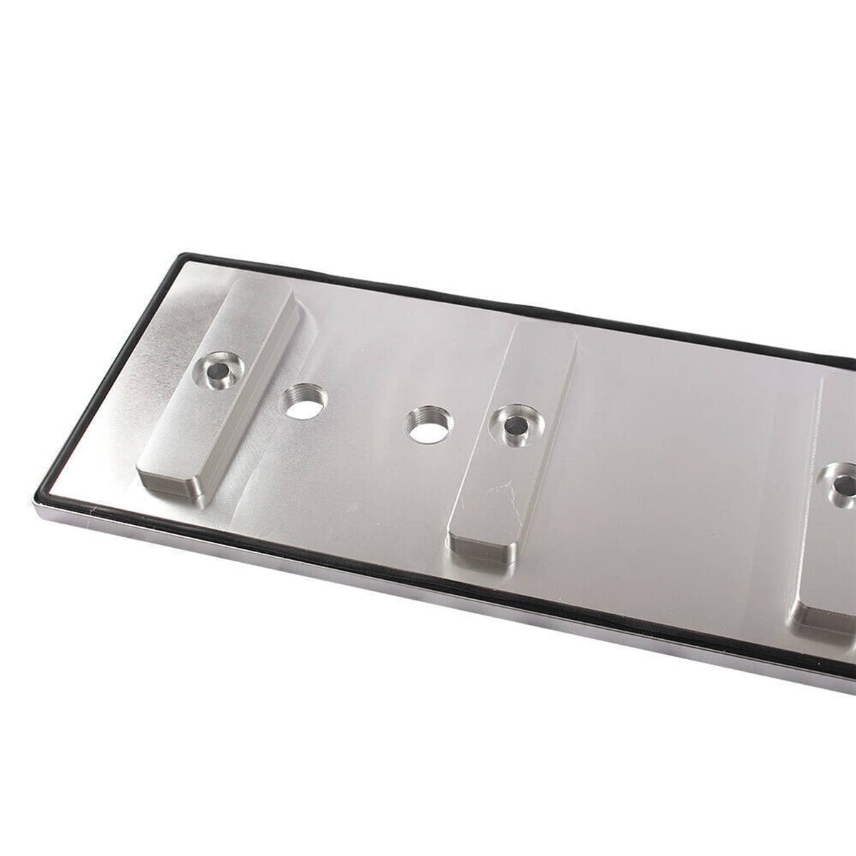 Machined aluminum tappet cover with cutouts and bolt holes, silver finish