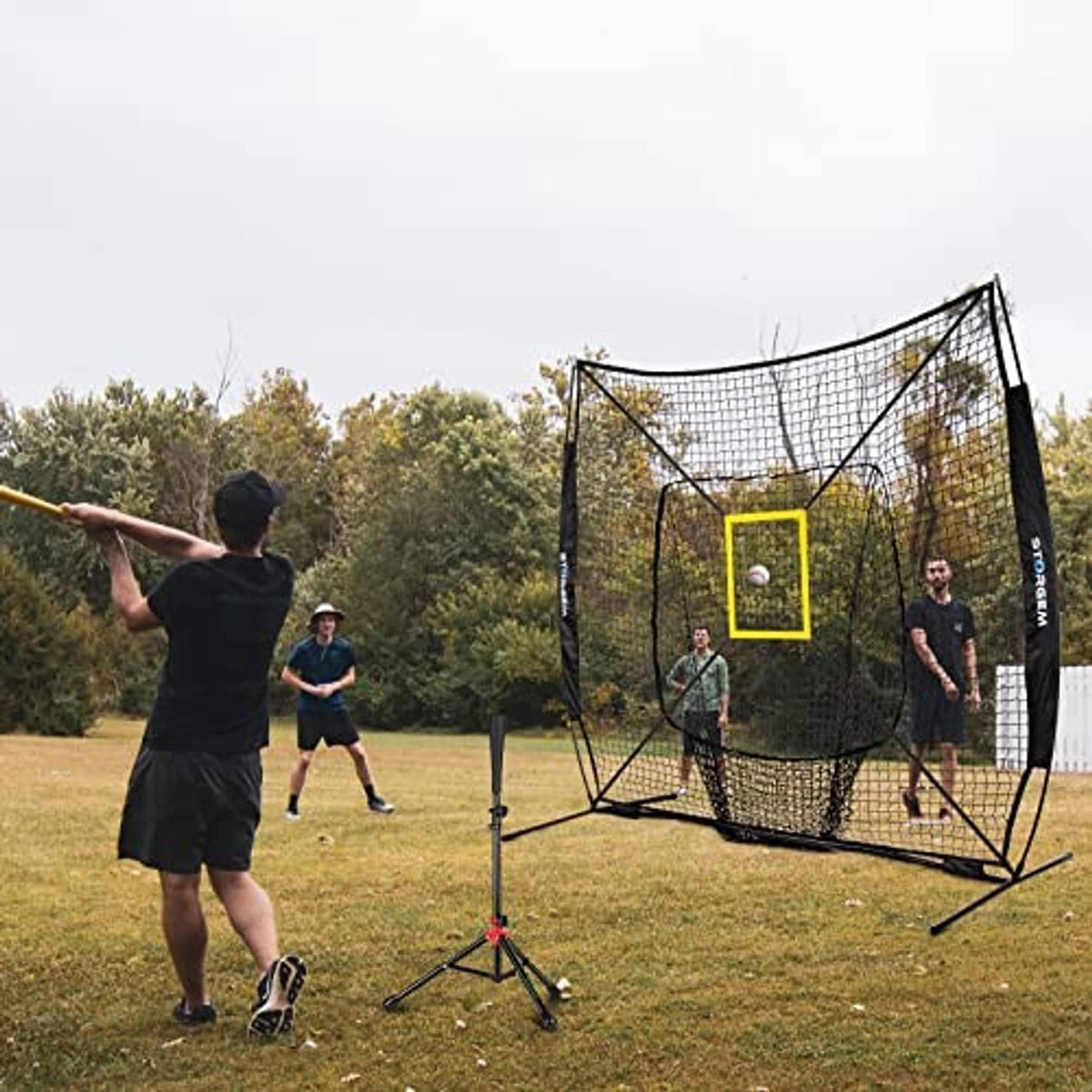 Baseball practice net with yellow strike-zone square target and black frame on the field
