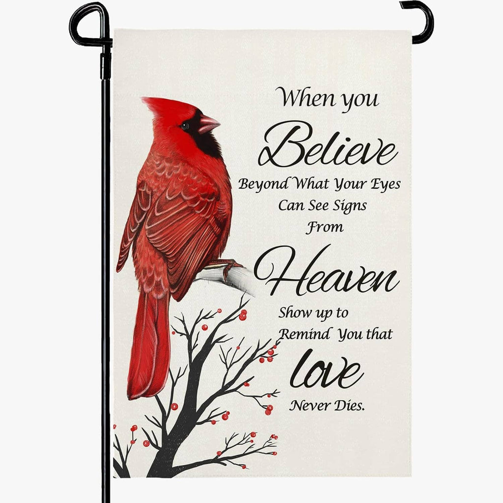 Red cardinal garden flag with white background, “Believe” message, and tree branches