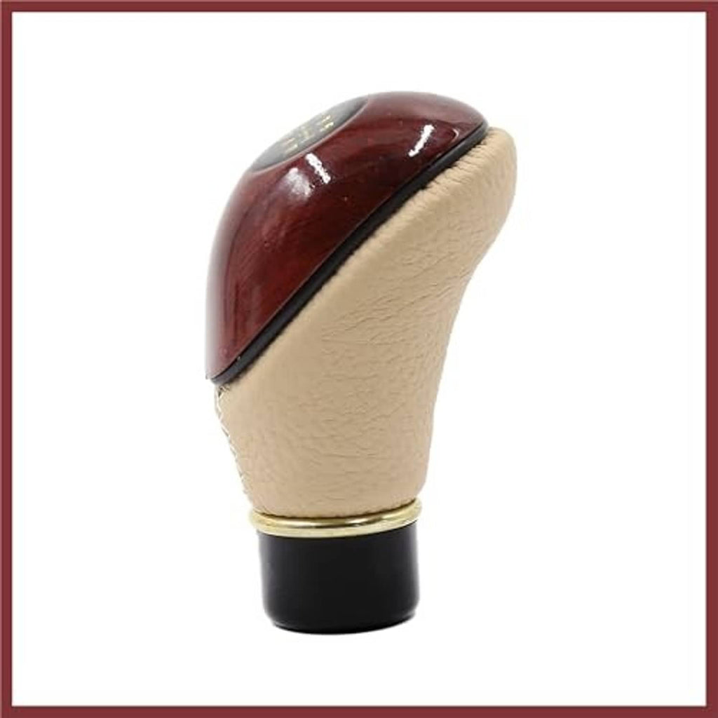 Beige gear shift knob with brown top panel, gold ring, and black base