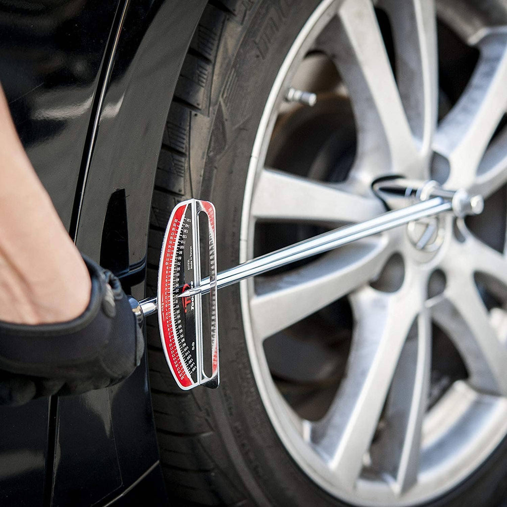 Torque wrench applying to tire wheel lug area with red scale