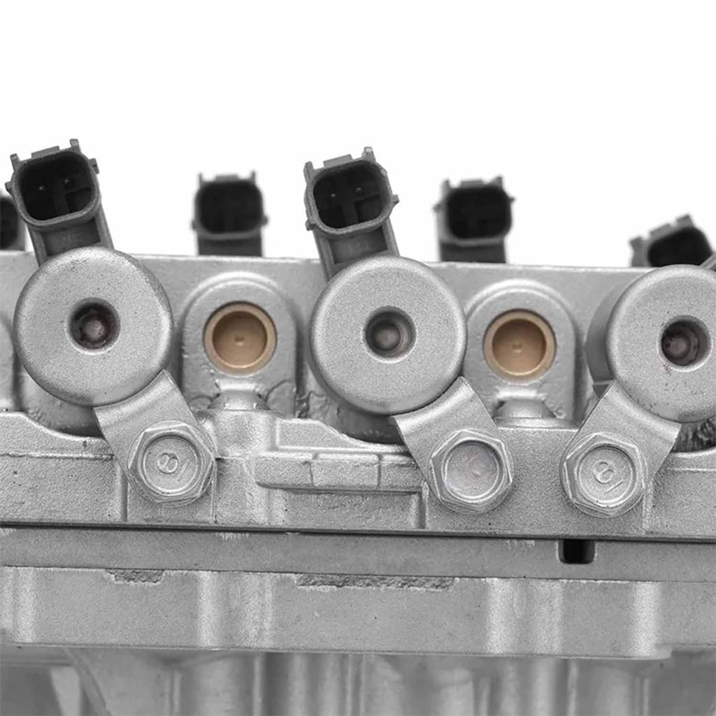 Vehicle valve body assembly close-up row of round ports with black electrical connectors