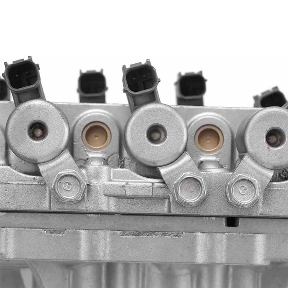 Vehicle valve body assembly close-up row of round ports with black electrical connectors