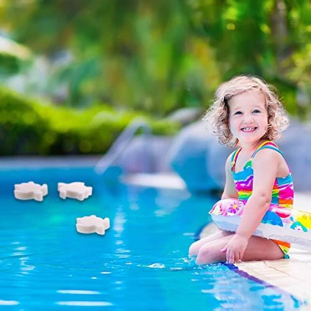 Child playing with a few white turtle-shaped foam sponges floating in pool water