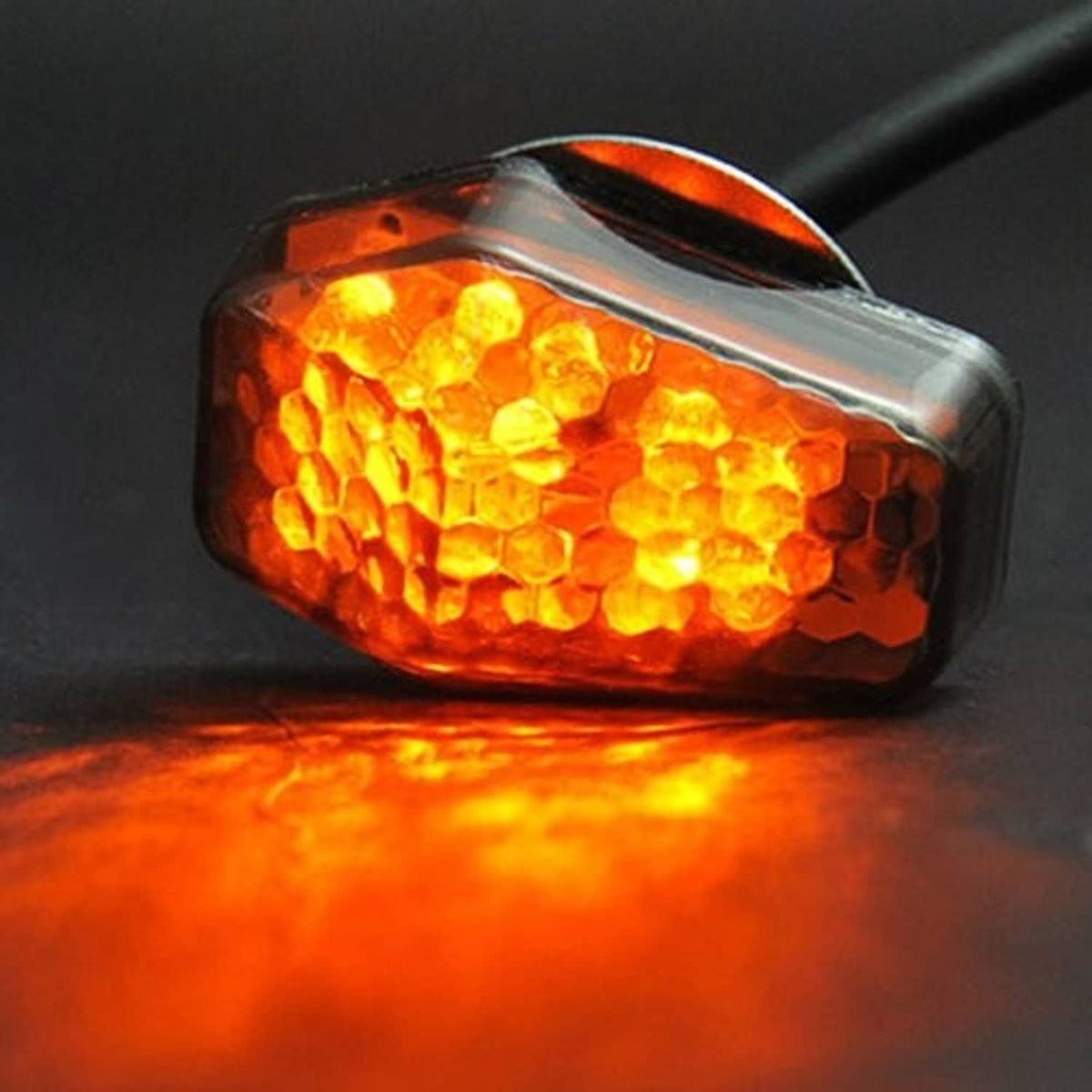 Amber LED turn signal indicator lit, smoke-lens housing with chrome edge and black wire