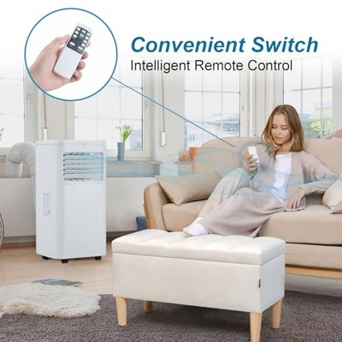 White portable air conditioner beside sofa, with remote control held in hand