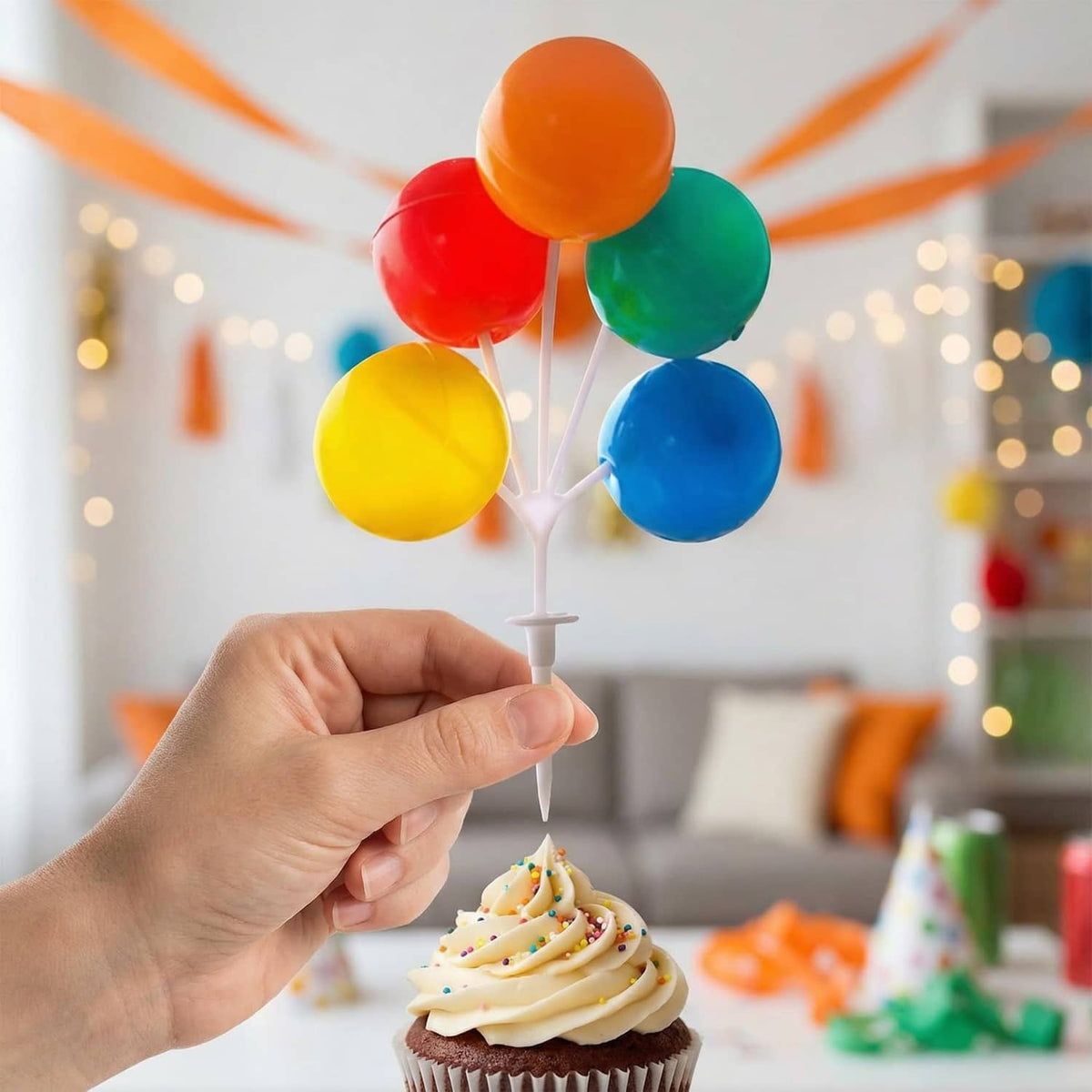 Balloon cake topper on a white stem with orange, red, green, yellow, and blue balloons